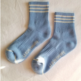 Blue socks with white stripes on a light grey background