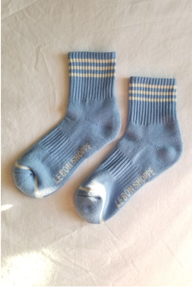 Blue socks with white stripes on a light grey background