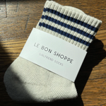 Oatmeal socks with navy stripes on wood background