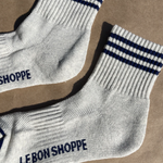 Oatmeal socks with navy stripes on kraft paper background