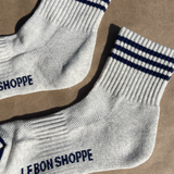 Oatmeal socks with navy stripes on kraft paper background