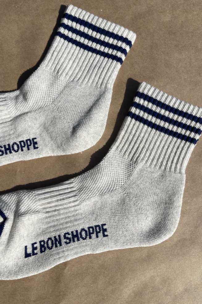 Oatmeal socks with navy stripes on kraft paper background