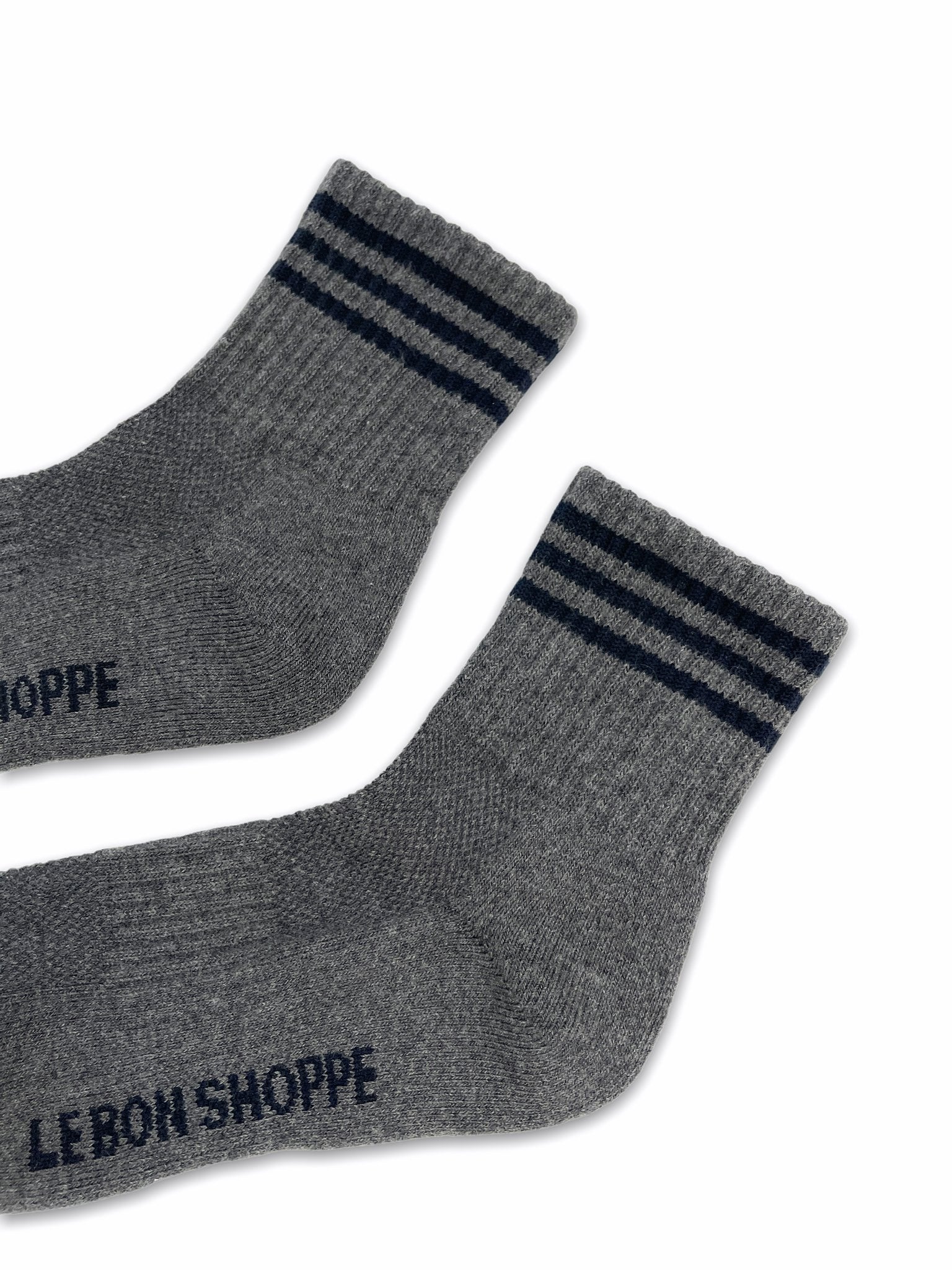 Grey socks with black stripes on white background