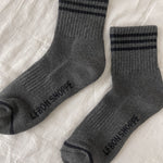 Grey socks with black stripes on white background