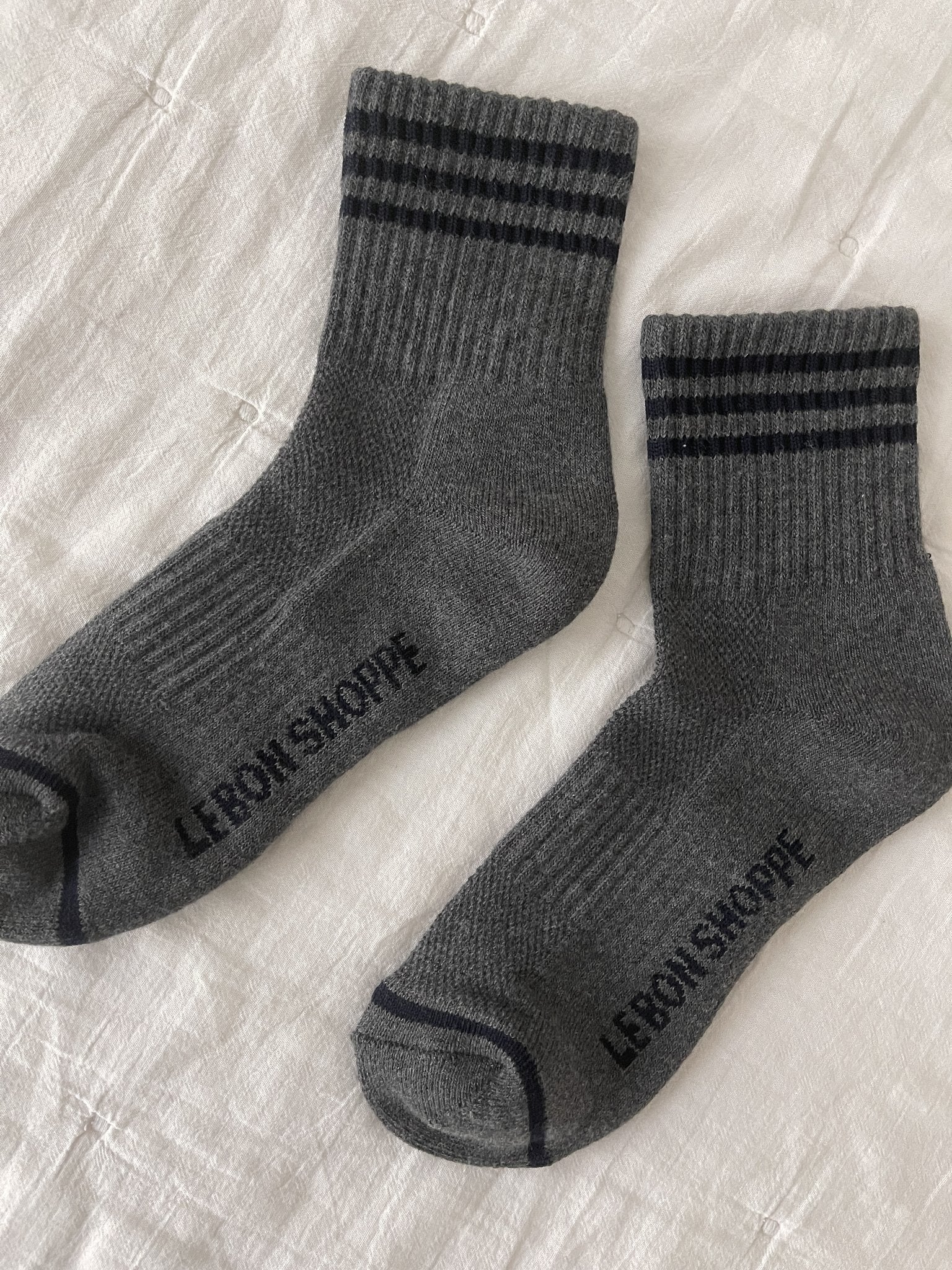 Grey socks with black stripes on white background