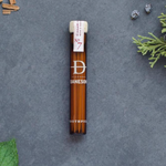 Glass bottle with toothpicks inside it.