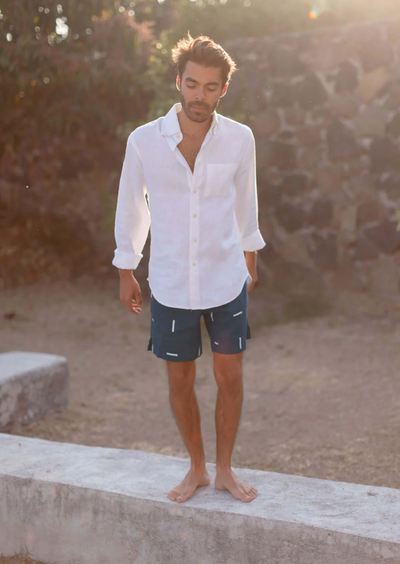 Man in linen shirt and blue and white printed linen shorts