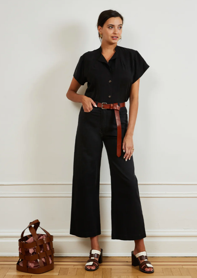 Women in black top and black, high-waisted, wide leg jeans