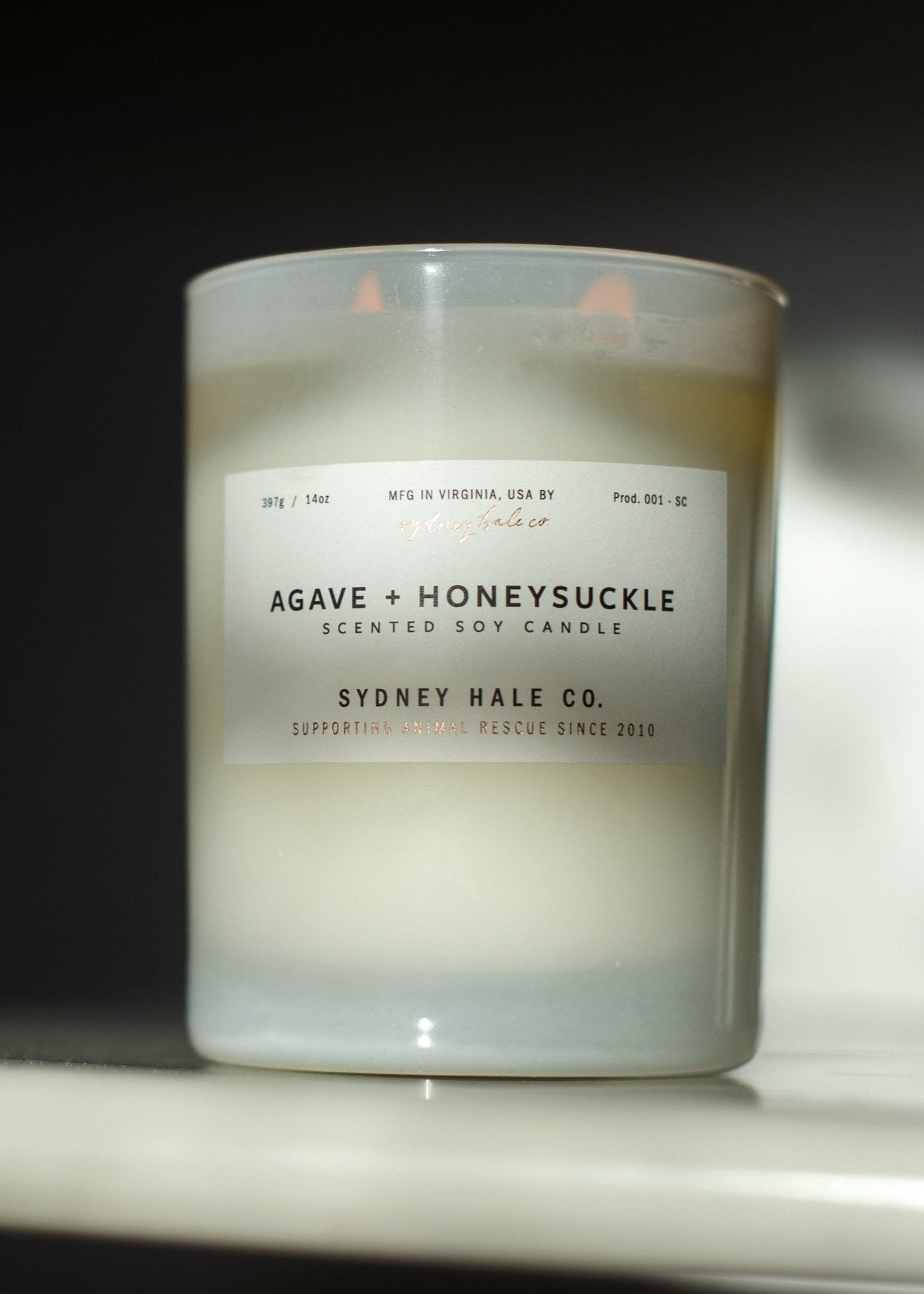 Candle in frosted white glass vessel