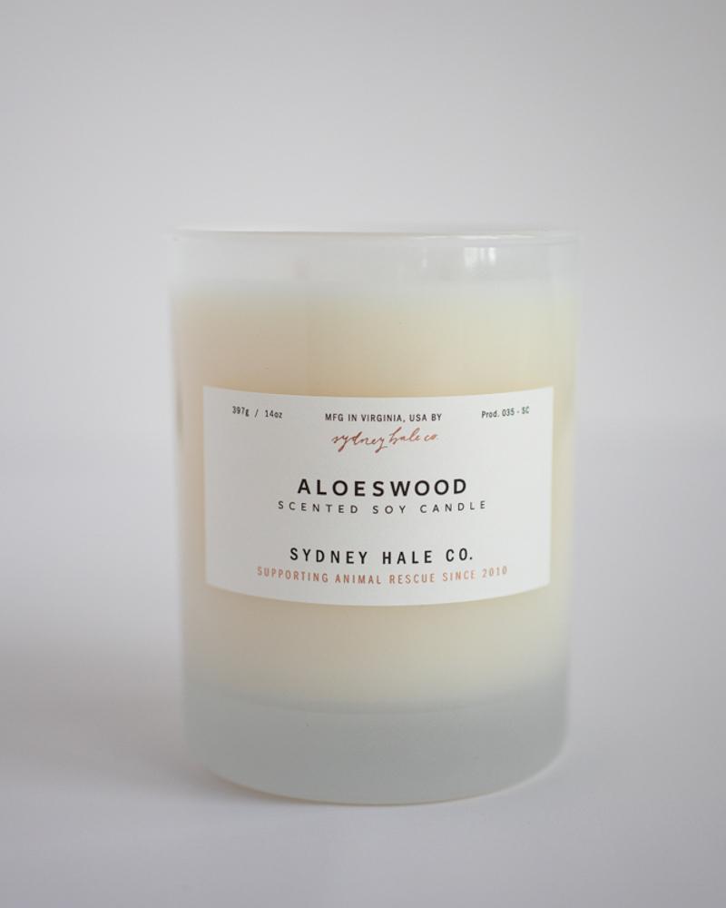 Candle in a frosted cream glass vessel