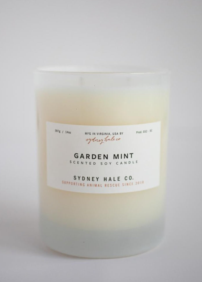 Candle in a frosted cream glass vessel
