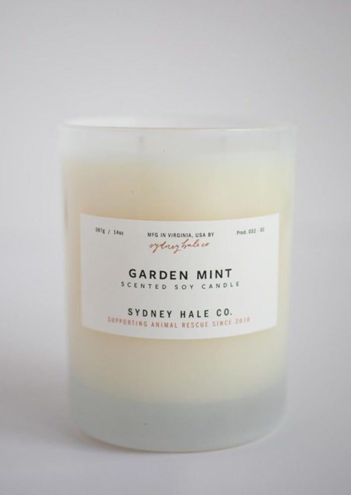 Candle in a frosted cream glass vessel