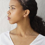 Woman wearing delicate gold necklace