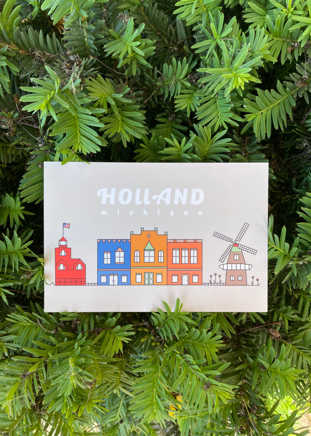 Holland Michigan Tan Postcard with imagery of downtown, big red lighthouse and a windmill.