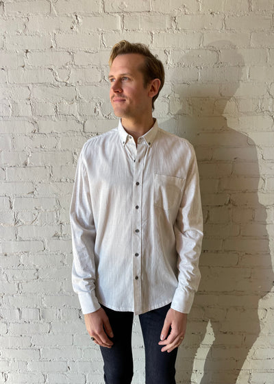 Man wearing White button up shirt and black jeans