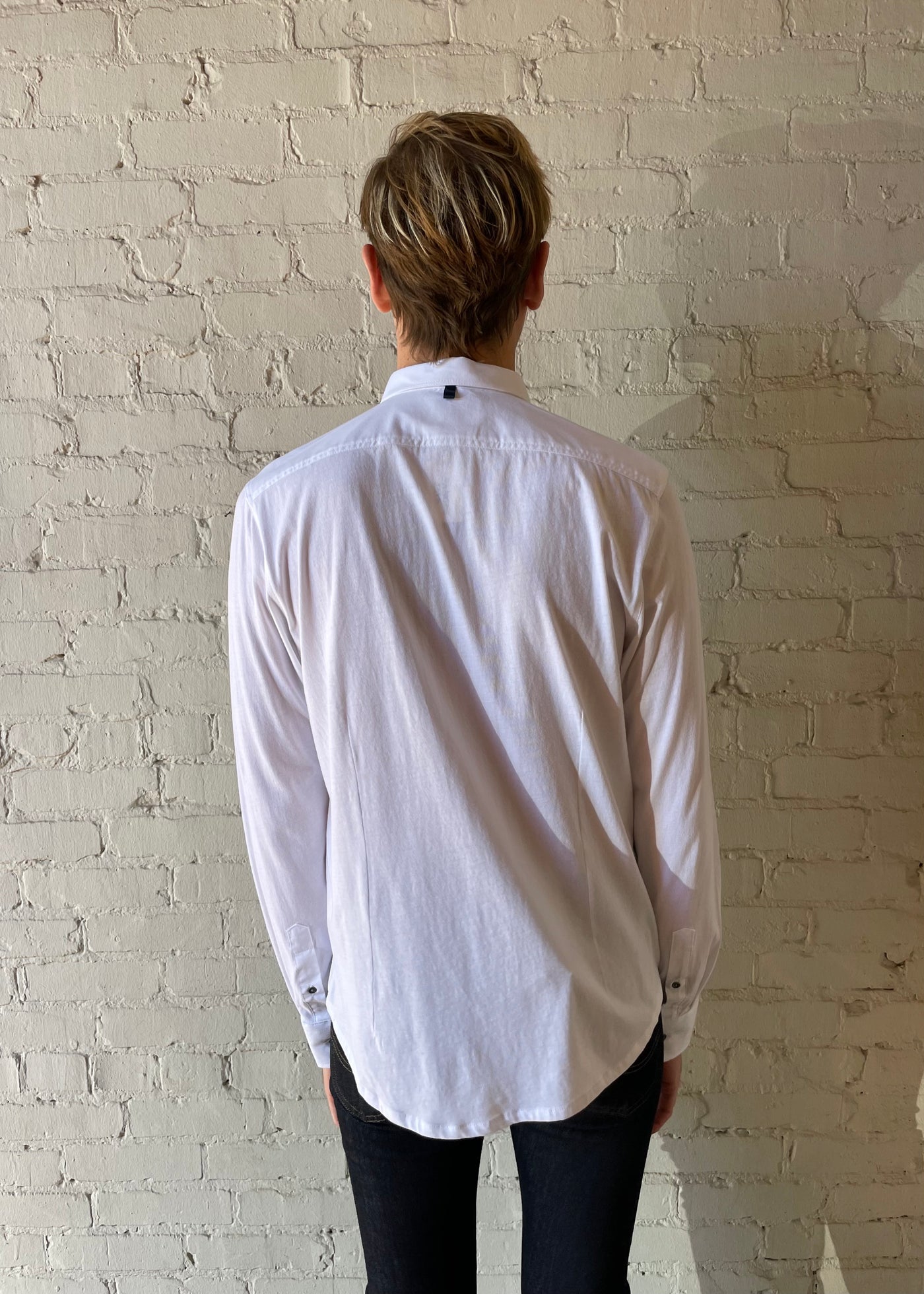 Male model wearing white button down shirt