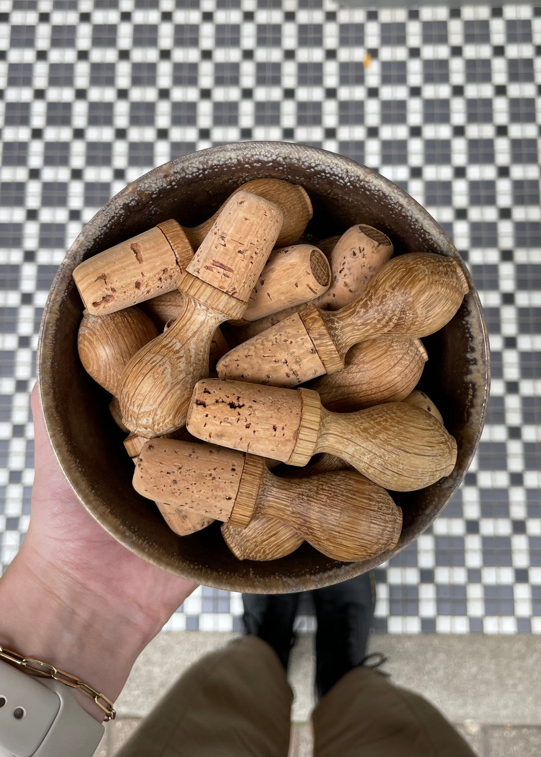 A bowl of oak wine stoppers in a ceramic bowl.