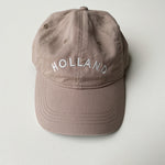 Tan baseball hat embroidered with Holland