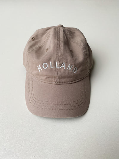 Tan baseball hat embroidered with Holland