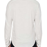 Man wearing White button up shirt and black jeans